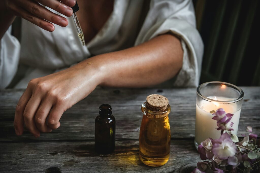 A woman putting ayurvedic serum on her wrists