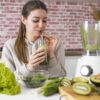 woman drinking green smoothie
