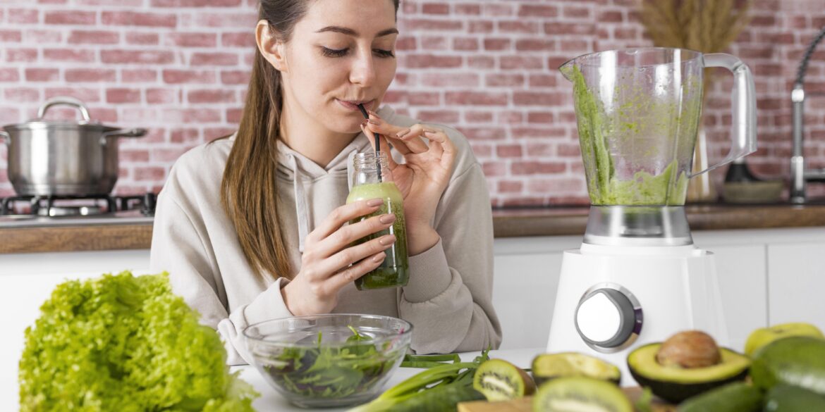 woman drinking green smoothie
