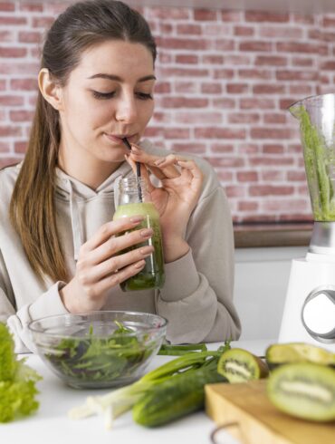 woman drinking green smoothie