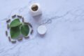 white ayurvedic medicine bottle and herbs