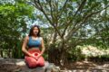 a woman doing a yoga pose in nature