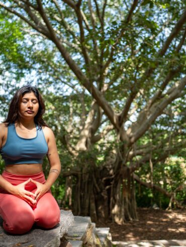 a woman doing a yoga pose in nature