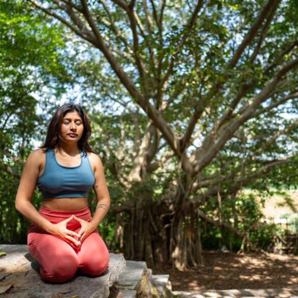 a woman doing a yoga pose in nature
