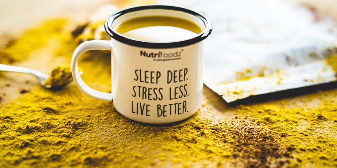 cup filled with yellow liquid that has a motivational quote written on it