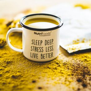 cup filled with yellow liquid that has a motivational quote written on it