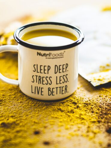 cup filled with yellow liquid that has a motivational quote written on it