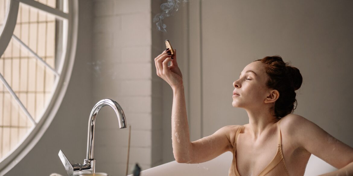 a woman lighting an incense