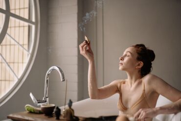 a woman lighting an incense