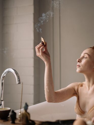 a woman lighting an incense
