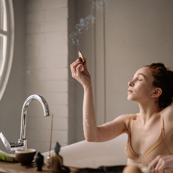 a woman lighting an incense