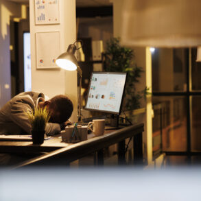 tired drained employee sleeping on the desk