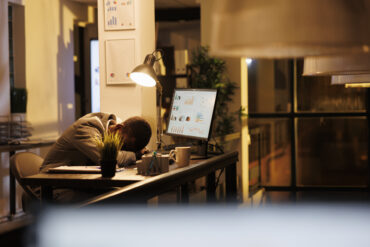 tired drained employee sleeping on the desk