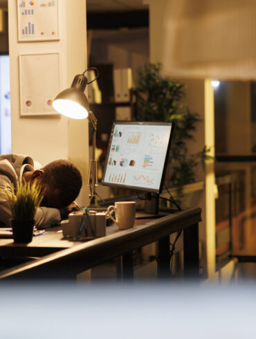tired drained employee sleeping on the desk