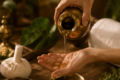 liquid being poured from copper glass onto a hand