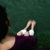 woman sitting with her legs spread out
