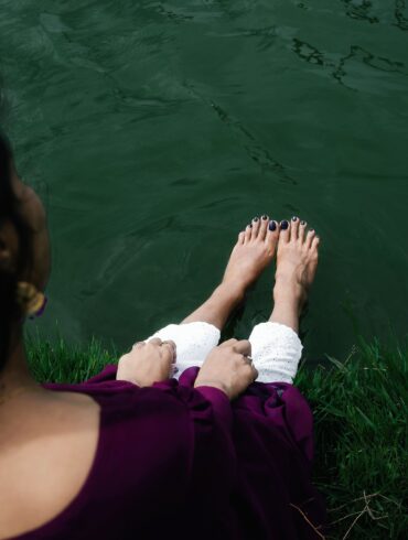 woman sitting with her legs spread out