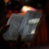 ayurvedic scripture held on a hand