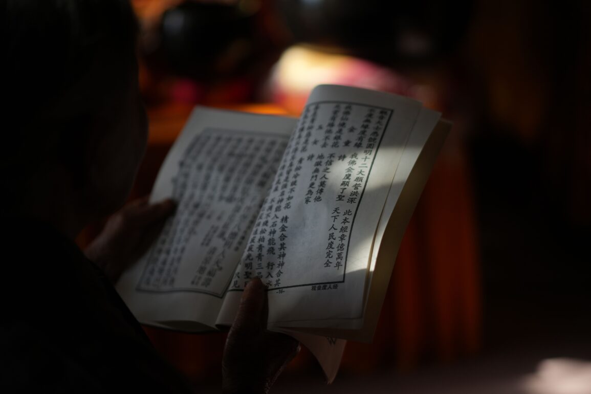 ayurvedic scripture held on a hand