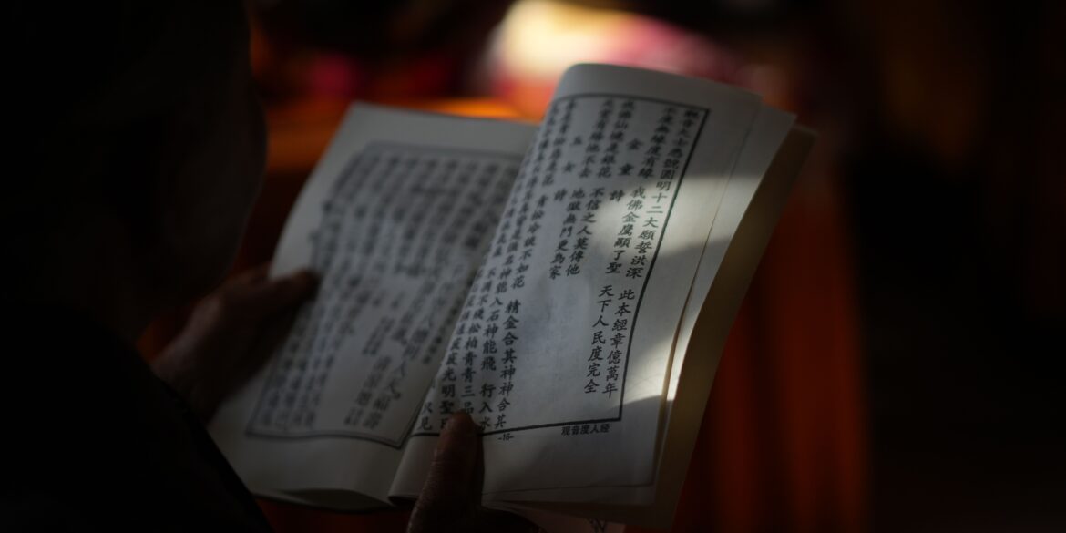 ayurvedic scripture held on a hand