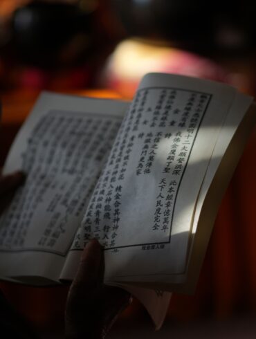 ayurvedic scripture held on a hand