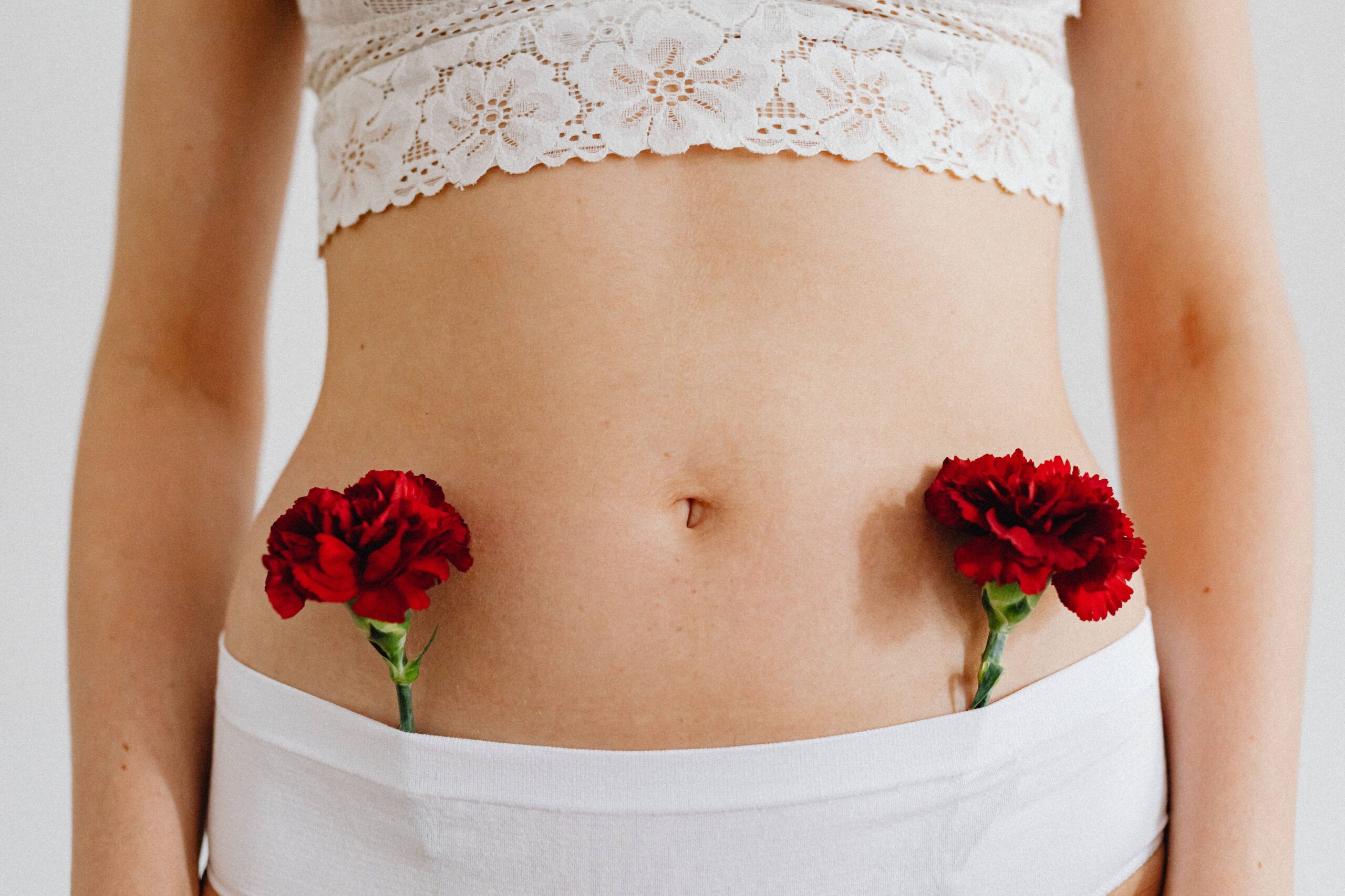 two flowers tucked in a girl's pant symbolic of Ayurvedic Hormonal Harmony
