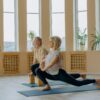 two healthy old man and woman doing a yoga pose