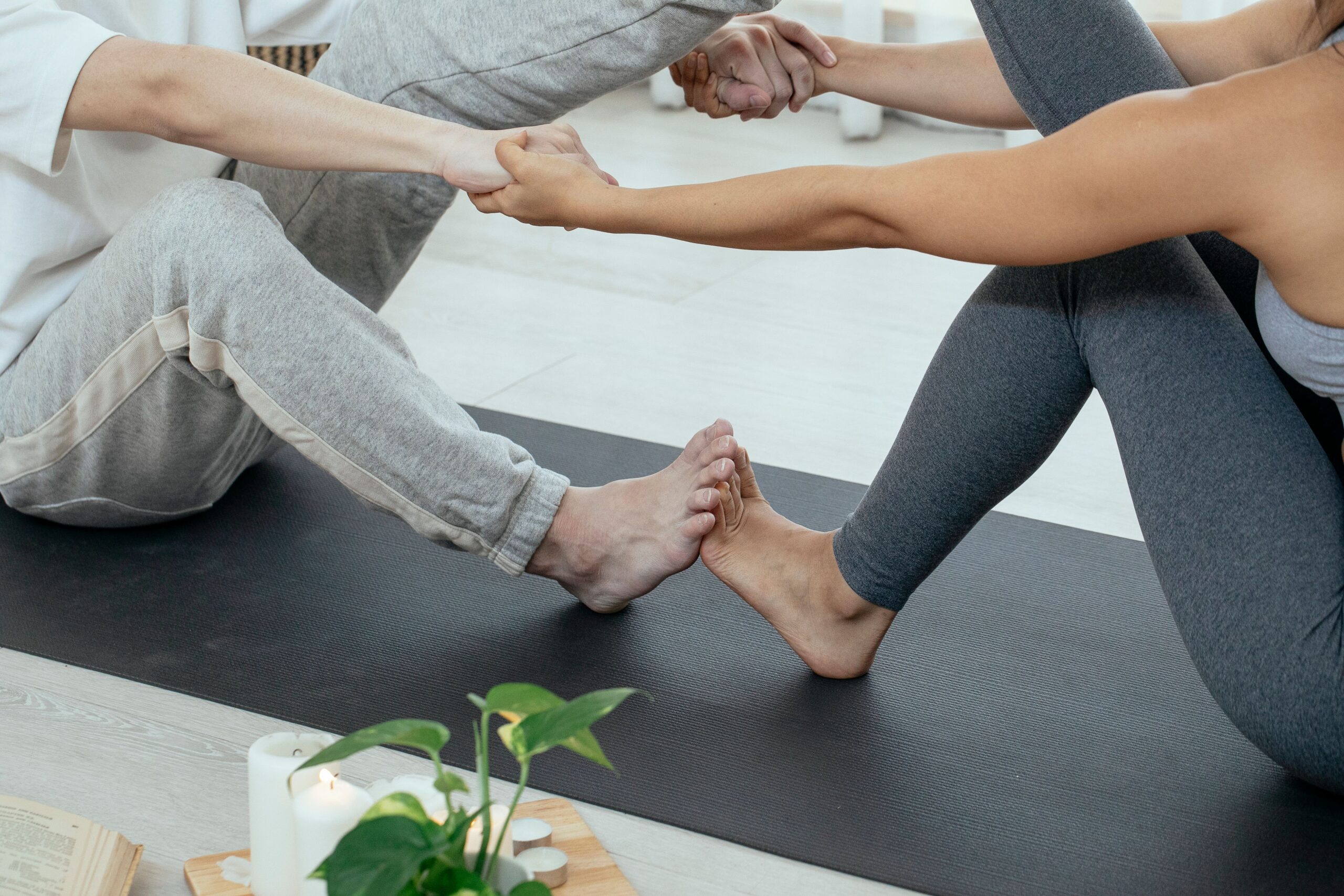 two people doing a yoga pose together for Ayurvedic Fitness for Busy Professionals