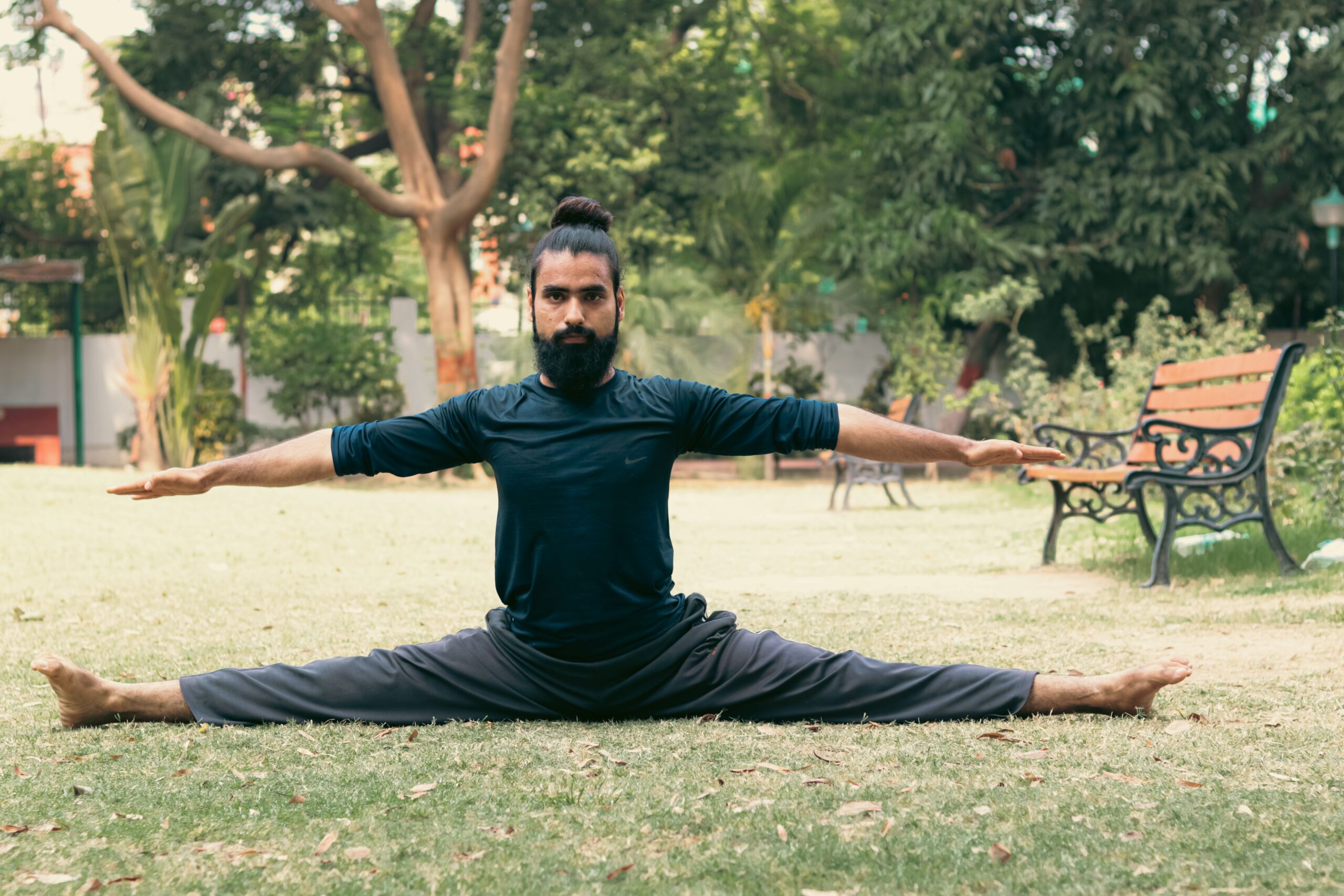 a man doing a yoga pose in nature for Ayurvedic Fitness Reset