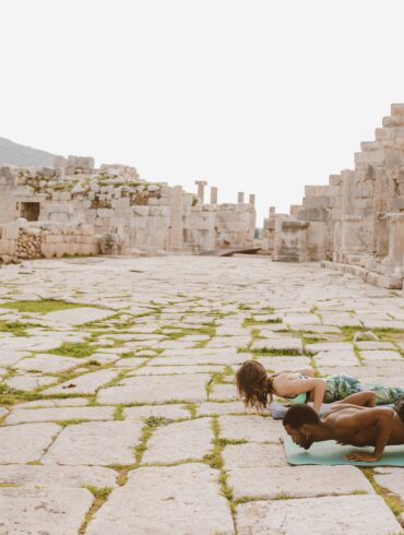 two people doing yoga poses