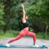 a woman doing a yoga pose in nature