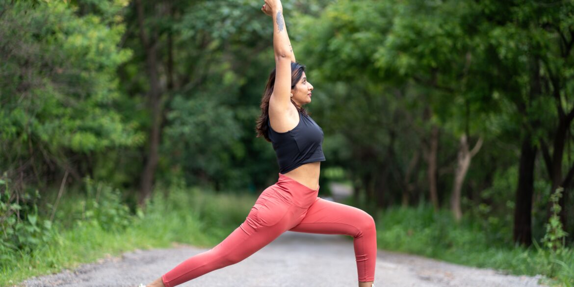 a woman doing a yoga pose in nature