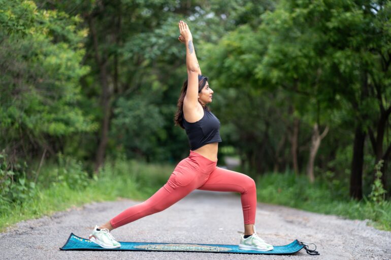 a woman doing a yoga pose in nature