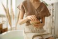 girl crushing ayurvedic herbs in a bowl