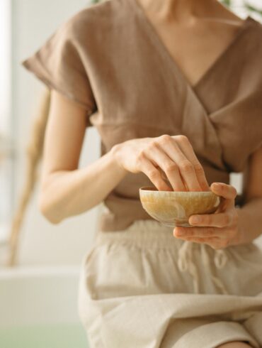 girl crushing ayurvedic herbs in a bowl