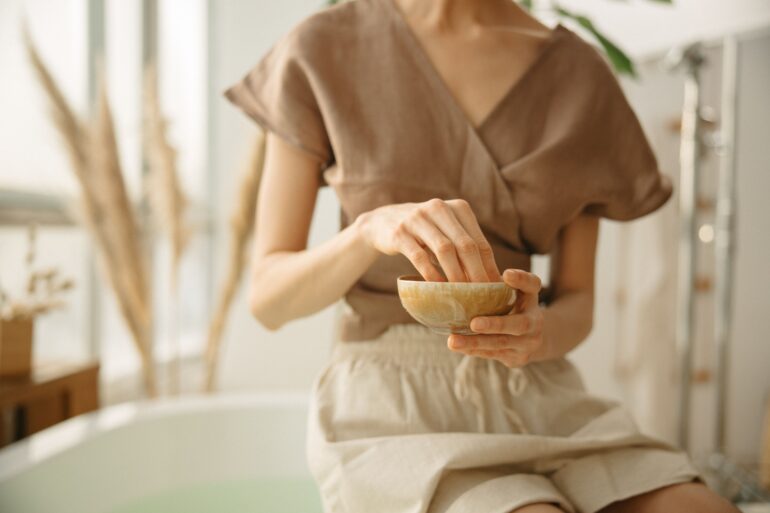 girl crushing ayurvedic herbs in a bowl