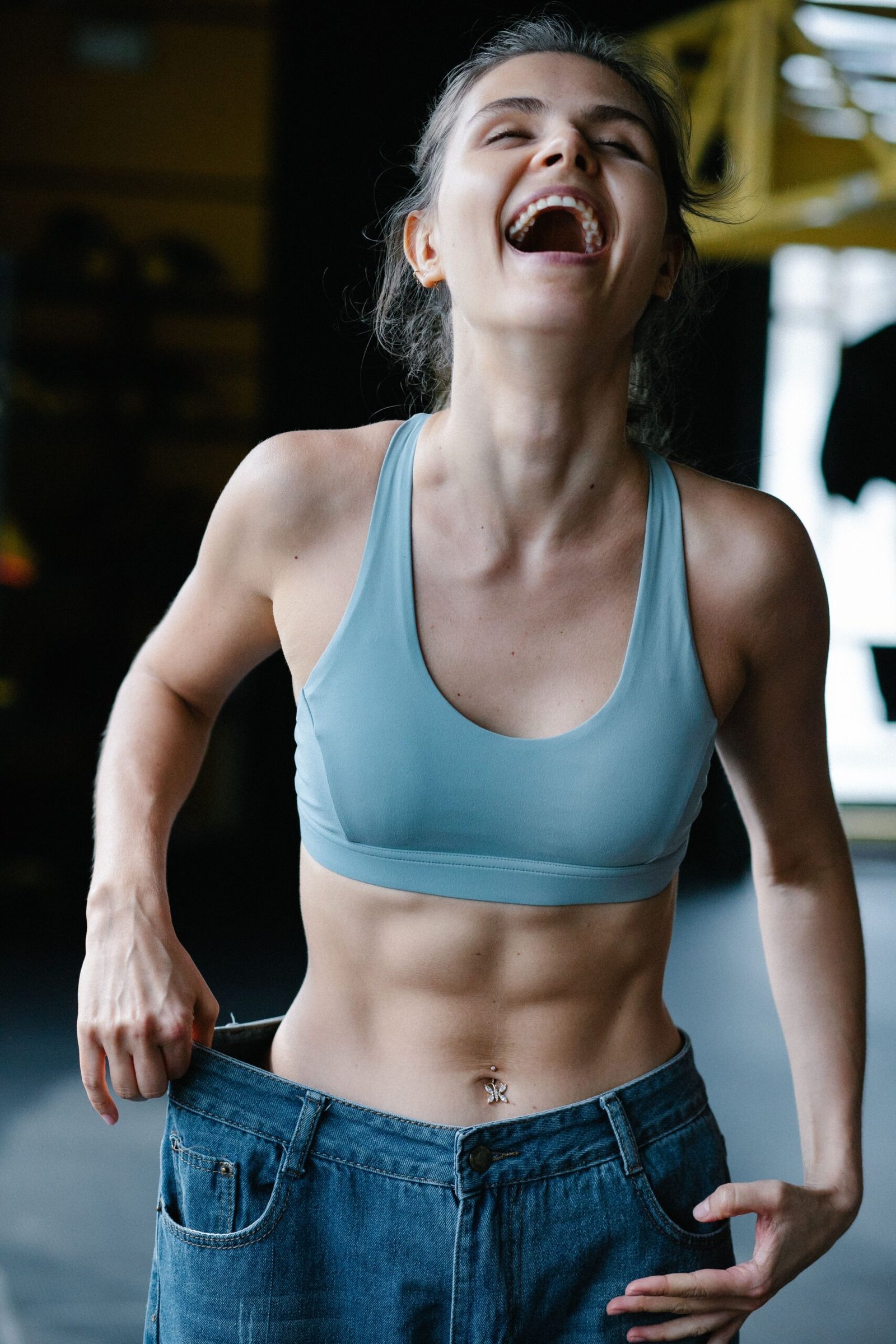 a girl holding out her loose pants symbolizing Metabolic Flexibility