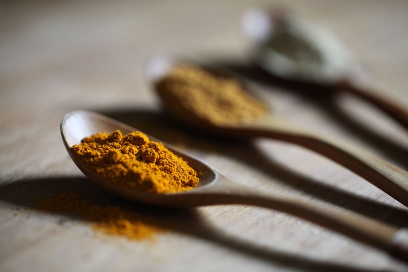turmeric on three spoons for Ayurvedic Hormone Balance Guide