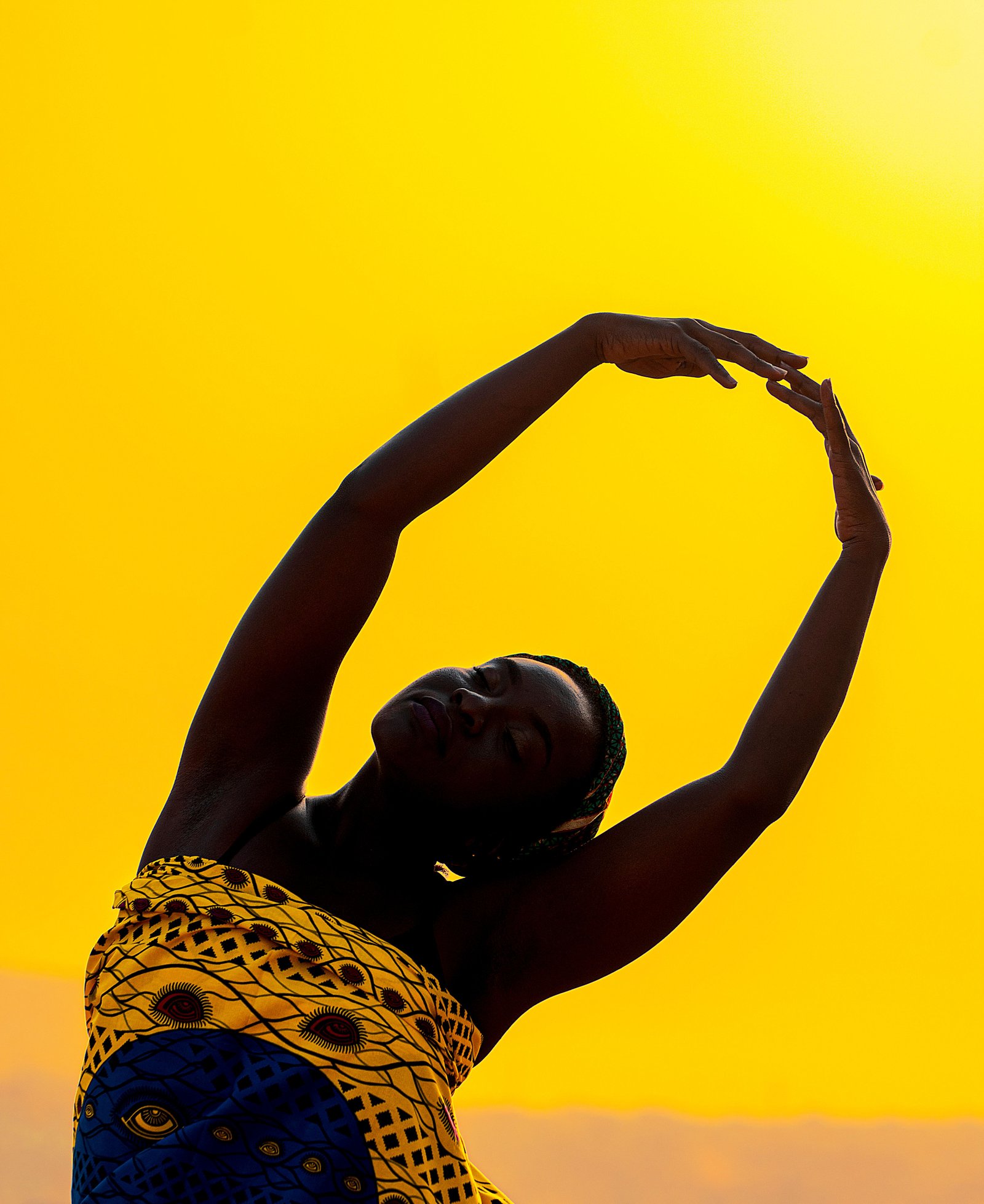 a girl stretching herself in a black background for energy