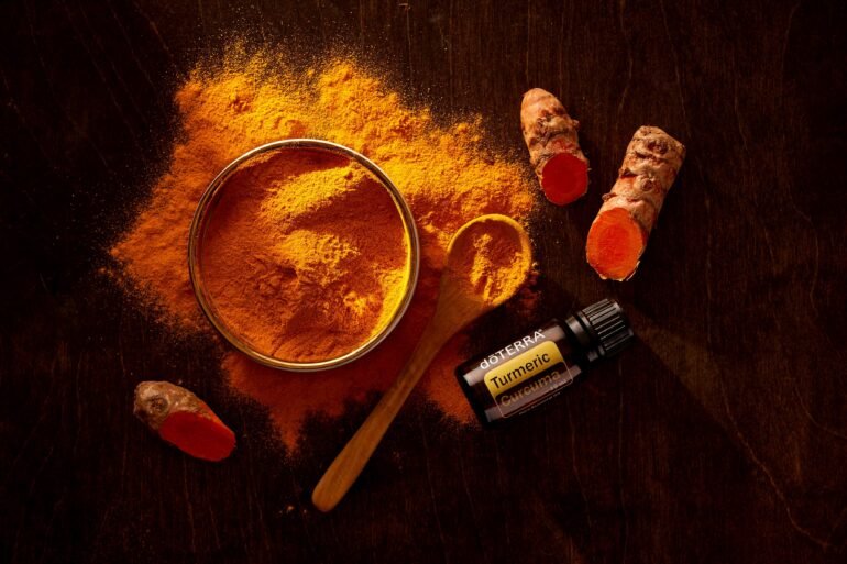 turmeric in a bowl, spoon and vials for Remedies for PCOS
