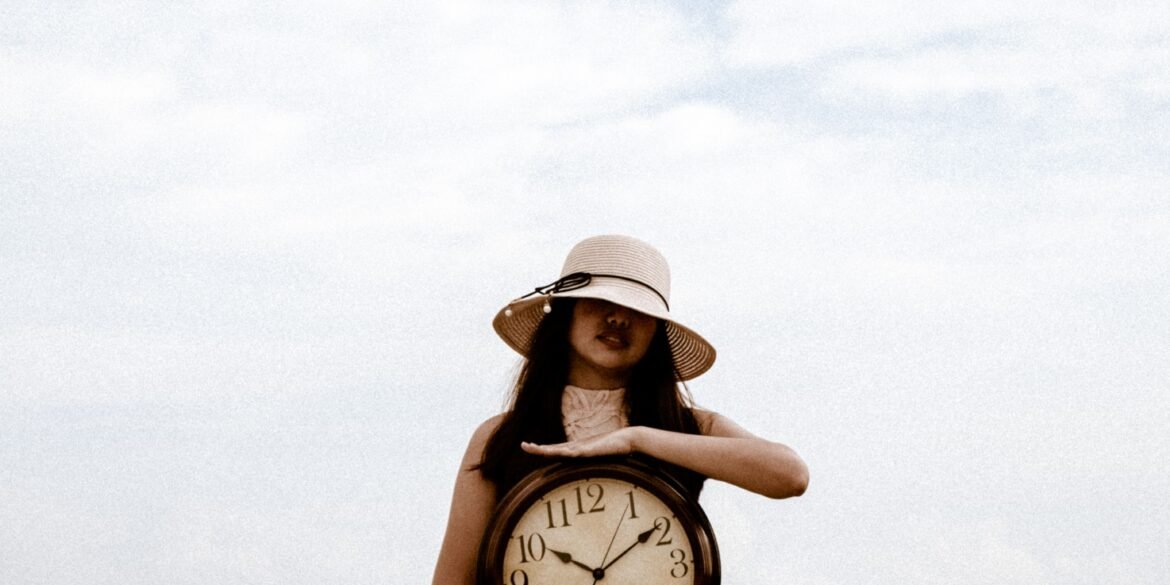 a woman holding a large clock
