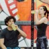 a boy and a girl drinking energy juice from bottles
