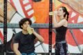 a boy and a girl drinking energy juice from bottles