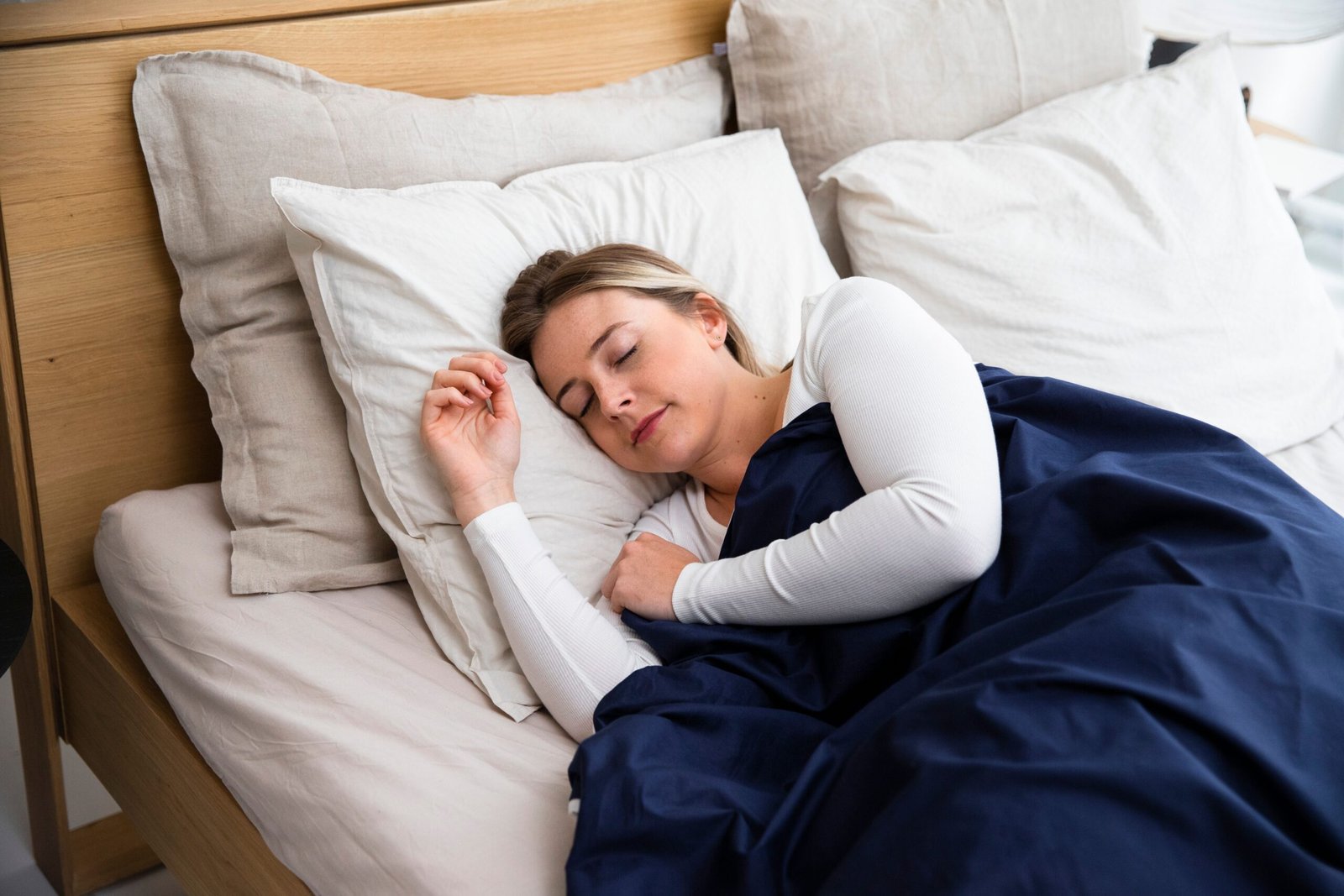 a woman sleeping with a blanket over her for deep sleep
