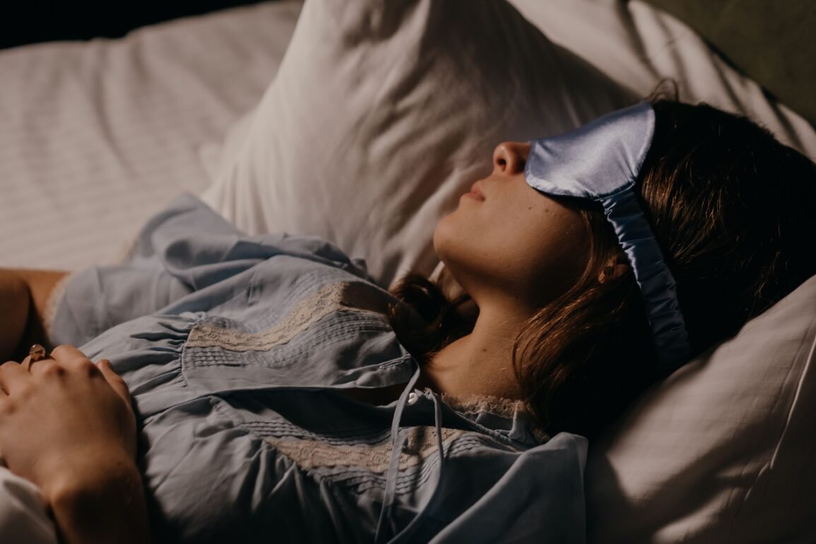 a woman sleeping peacefully with an eye mask on
