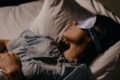 a woman sleeping peacefully with an eye mask on