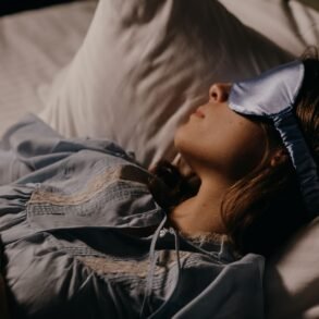 a woman sleeping peacefully with an eye mask on
