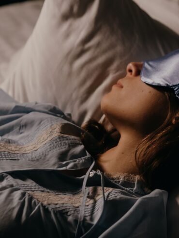 a woman sleeping peacefully with an eye mask on