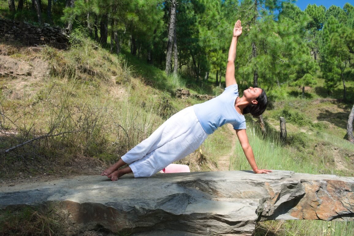 a woman doing yoga in nature for The Ayurvedic Fitness Blueprint