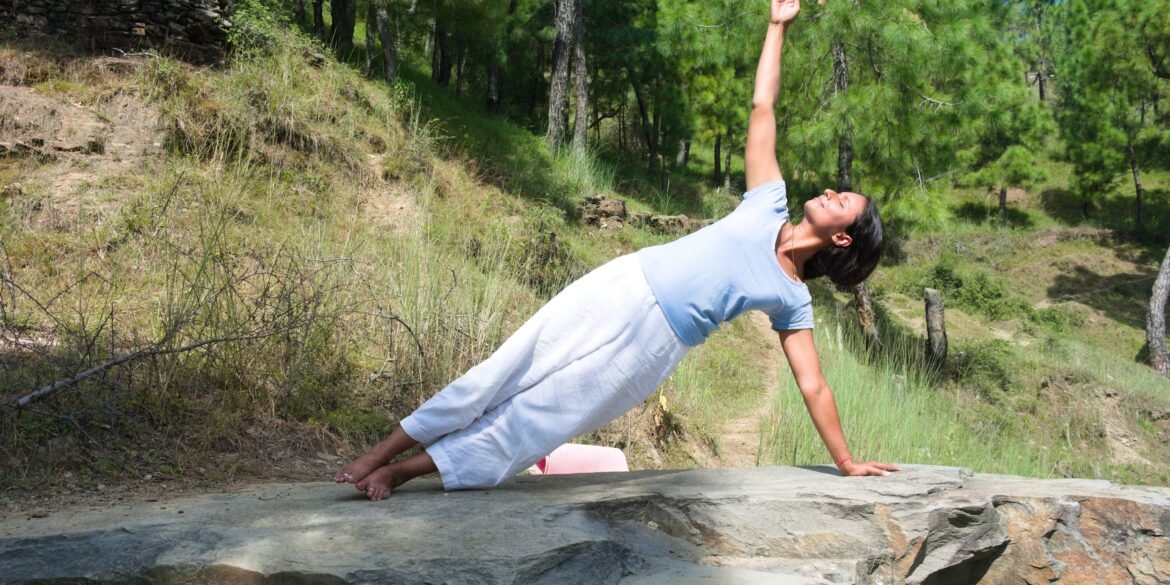 a woman doing yoga in nature for The Ayurvedic Fitness Blueprint